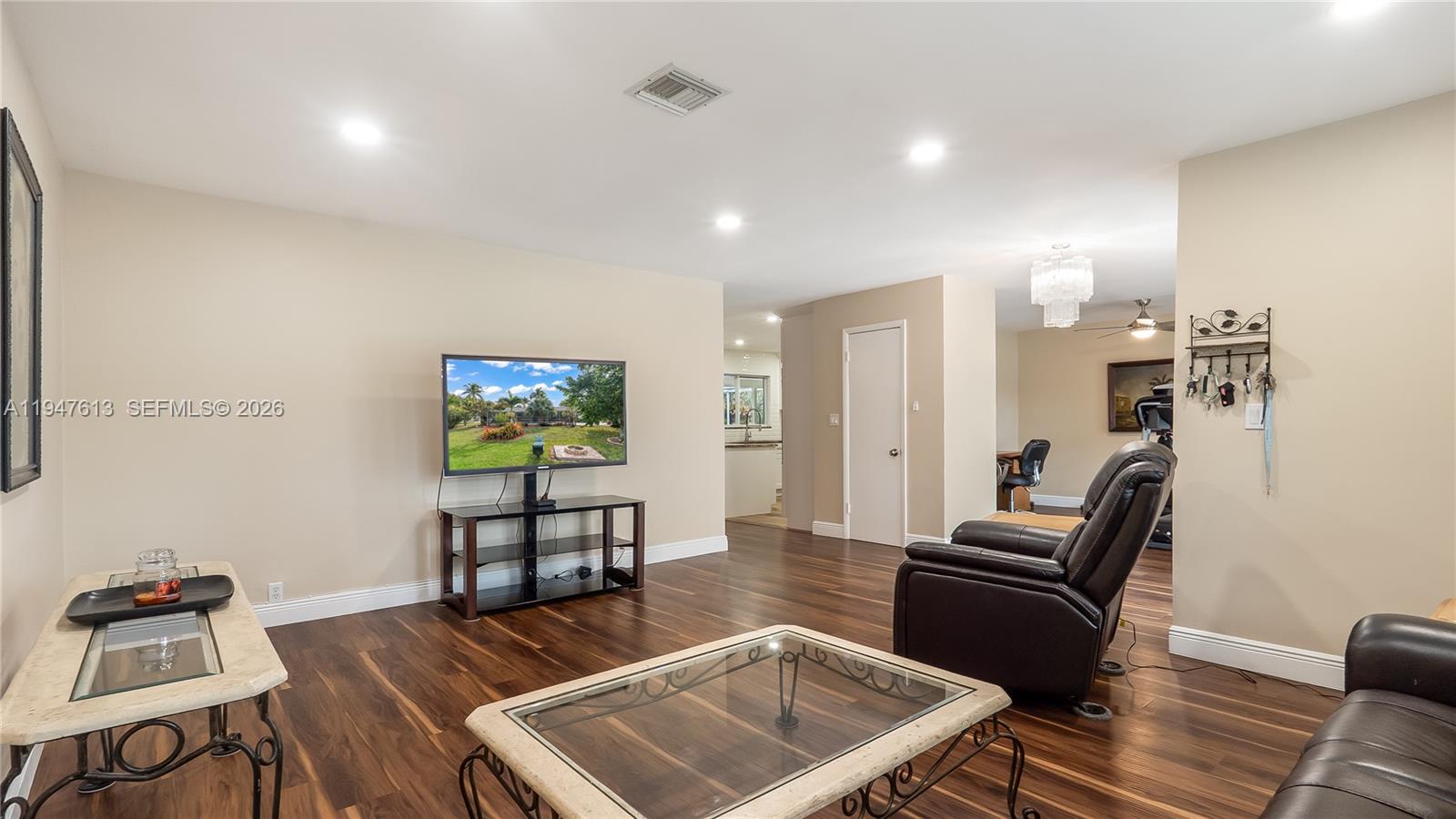 11071 Southwest 30th Court Davie, FL 33328 - Photo 3 of 44 a living room with furniture and a flat screen tv