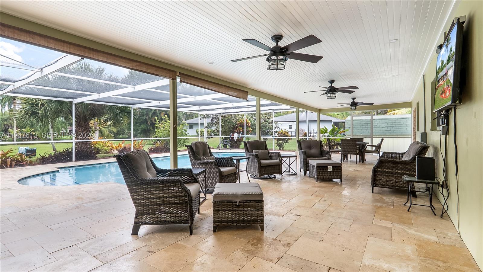 11071 Southwest 30th Court Davie, FL 33328 - Photo 32 of 44 a outdoor space with lots of chairs and large mirror