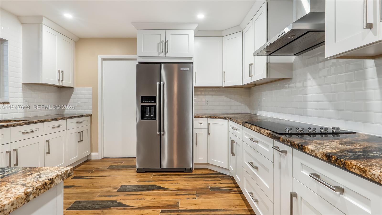 11071 Southwest 30th Court Davie, FL 33328 - Photo 9 of 44 a kitchen with stainless steel appliances granite countertop a refrigerator sink and cabinets