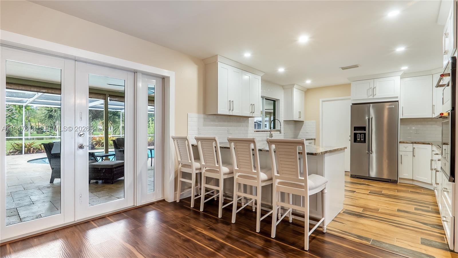 11071 Southwest 30th Court Davie, FL 33328 - Photo 10 of 44 a view of a kitchen with dining room and wooden floor