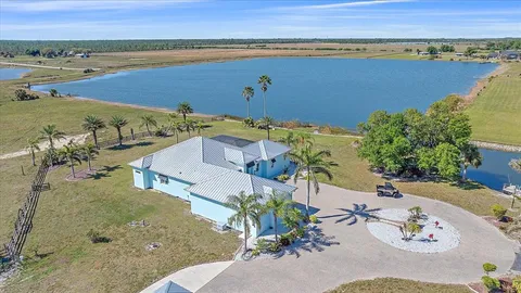 an aerial view of a house with a lake view