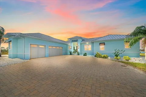 a kitchen with stainless steel appliances granite countertop a kitchen island a stove and a wooden floors