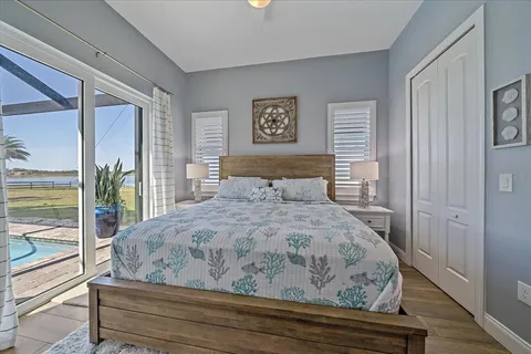 a bedroom with a bed and a flat tv screen on dresser