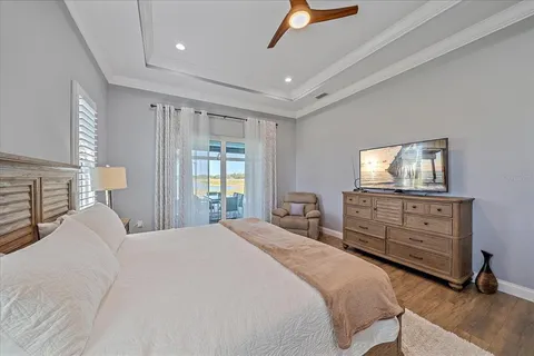 a bathroom with a granite countertop sink a toilet and a window