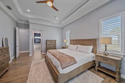 a living room with patio furniture and a chandelier