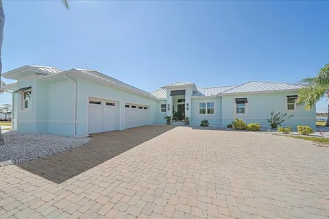 an aerial view of a house with large trees