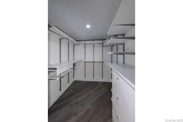 a kitchen with white cabinets and refrigerator