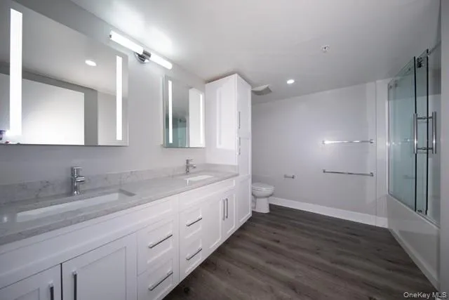 a bathroom with a double vanity sink and mirror