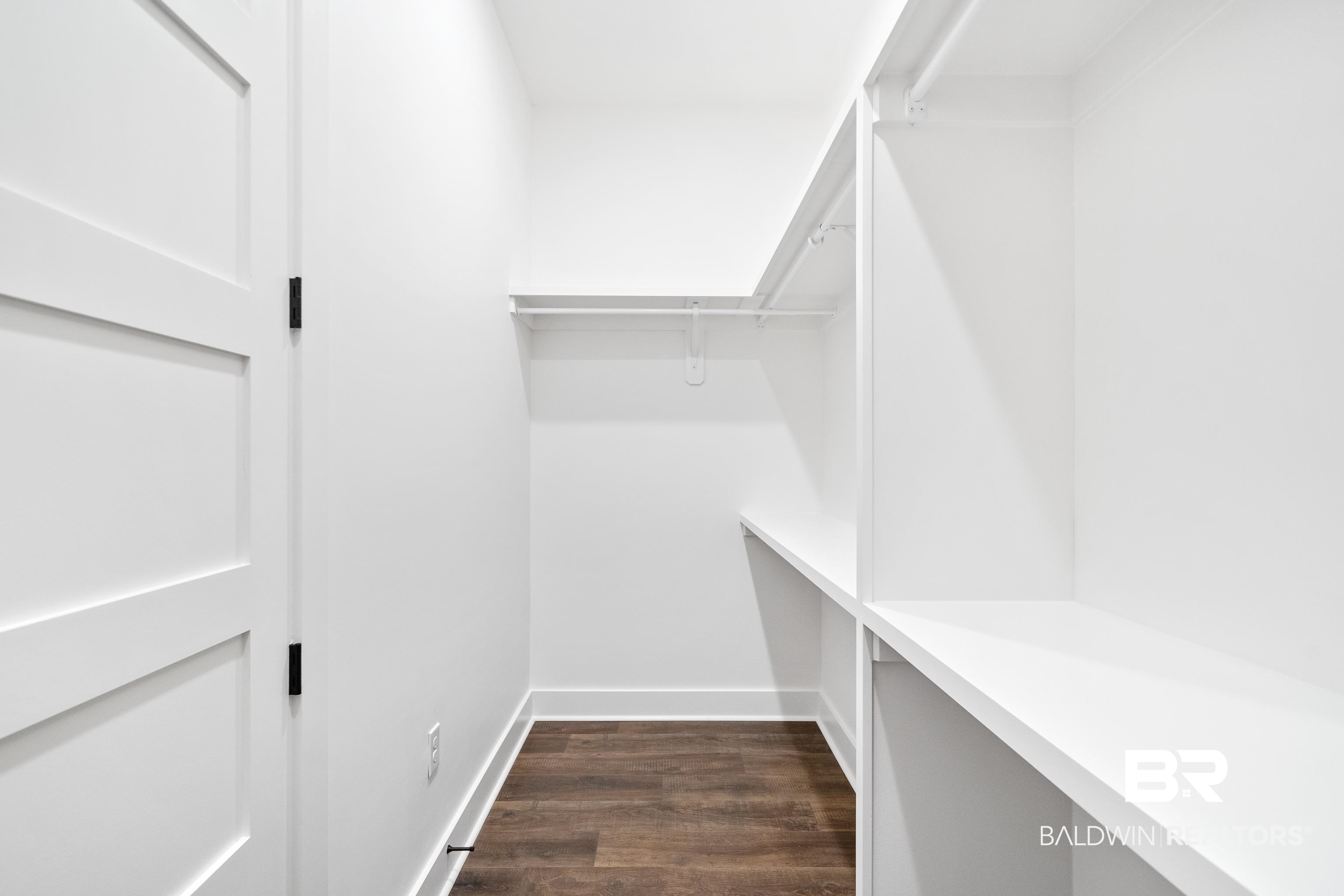 12453 County Road 1 Fairhope, AL 36532 - Photo 13 of 33 Walk in closet featuring dark wood-type flooring