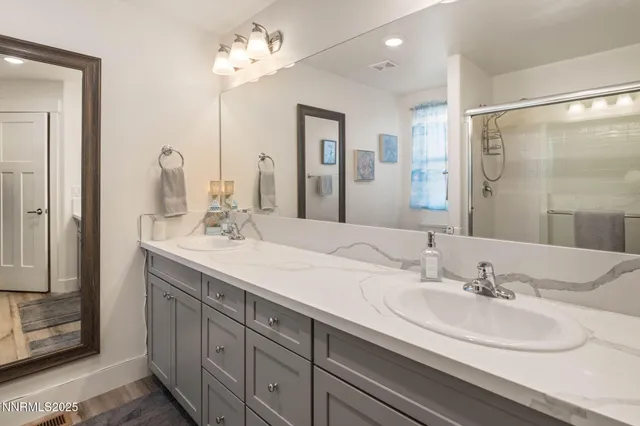 a bathroom with a double vanity sink mirror and double