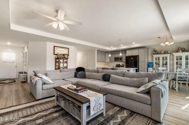 a living room with furniture ceiling fan and a rug
