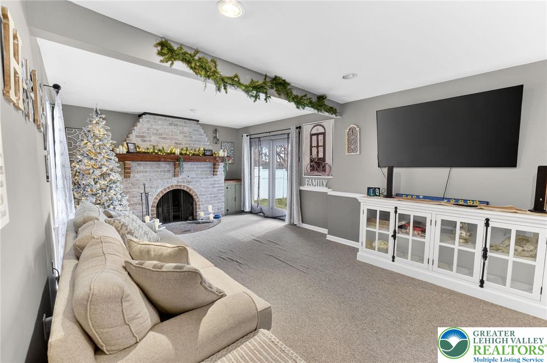 311 Lynoak Avenue Shillington, PA 19607 - Photo 9 of 40 a living room with furniture a flat screen tv and a fireplace