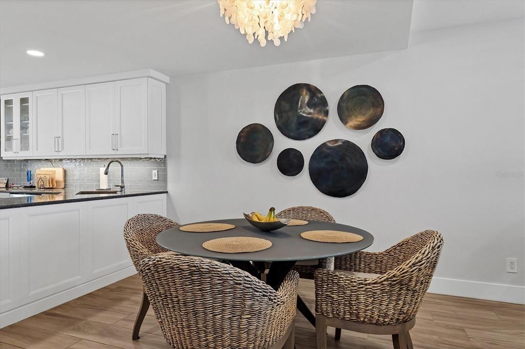 5740 Midnight Pass Road, Unit 303F Sarasota, FL 34242 - Photo 14 of 51 a table and chairs in a kitchen