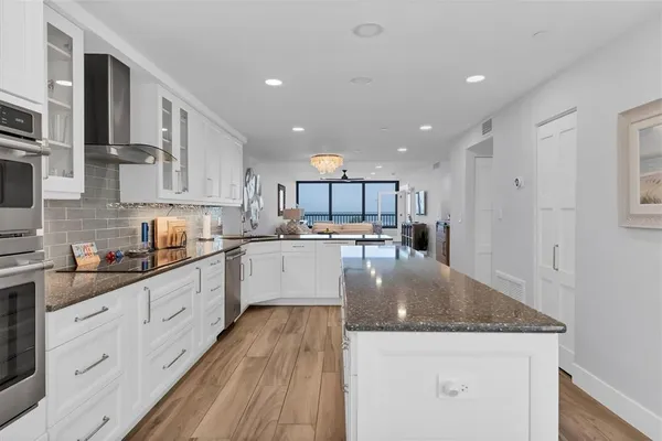 a kitchen with a sink a counter top space stainless steel appliances and cabinets