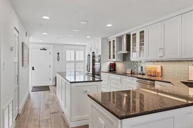 a kitchen with granite countertop a sink stove and cabinets