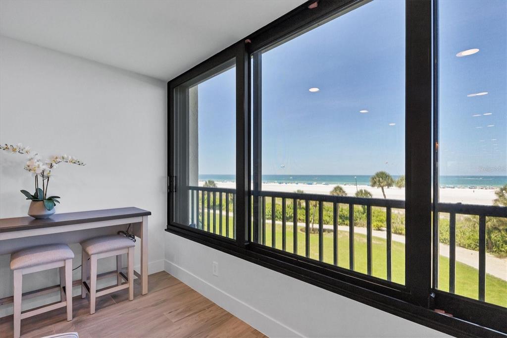 5740 Midnight Pass Road, Unit 303F Sarasota, FL 34242 - Photo 19 of 51 a view of a room with furniture and wooden floor