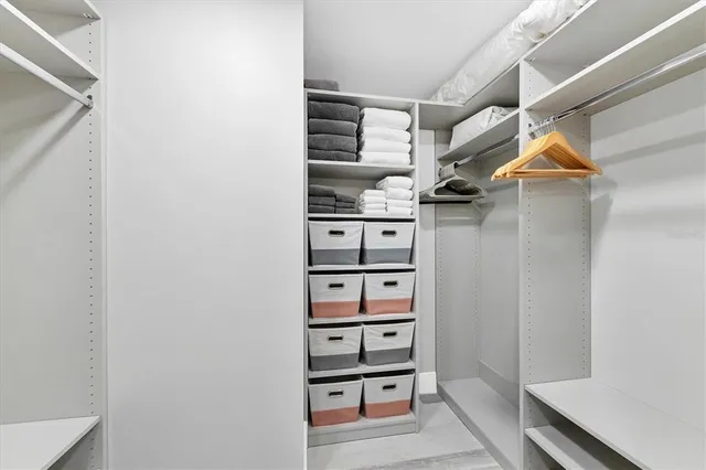 a view of walk in closet with empty racks