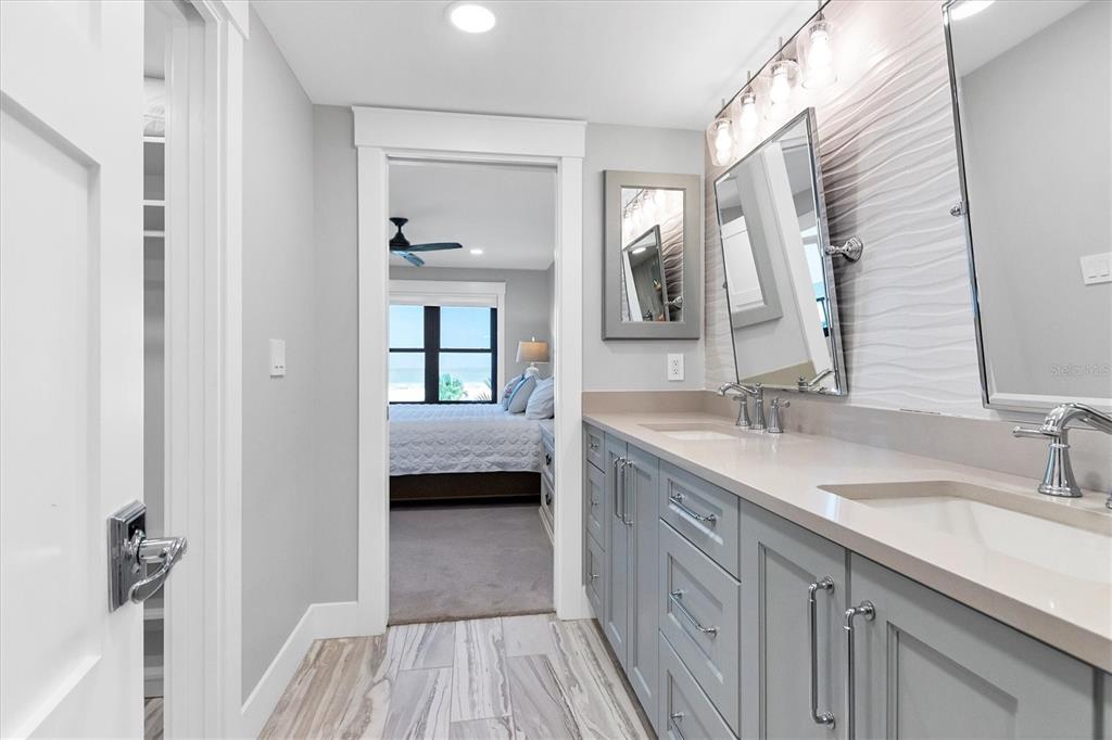 5740 Midnight Pass Road, Unit 303F Sarasota, FL 34242 - Photo 25 of 51 a en suite bathroom with a double vanity sink and mirror