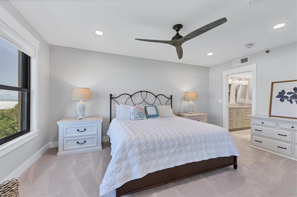 5740 Midnight Pass Road, Unit 303F Sarasota, FL 34242 - Photo 27 of 51 a bedroom with a bed a chandelier and a window