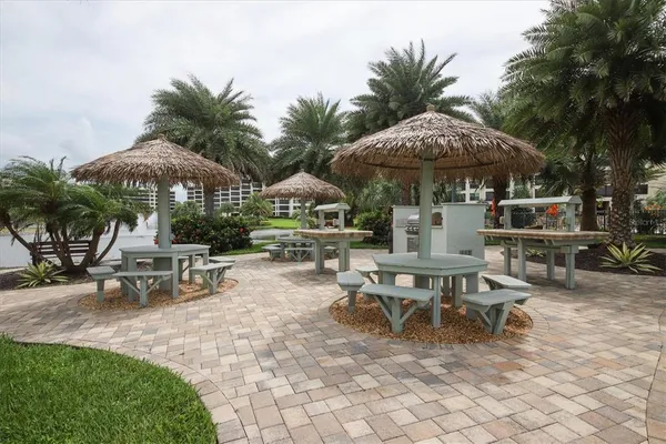 a view of a patio with a table and chairs under an umbrella