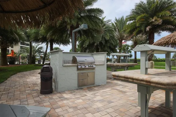 a view of a patio with a table and chairs under an umbrella