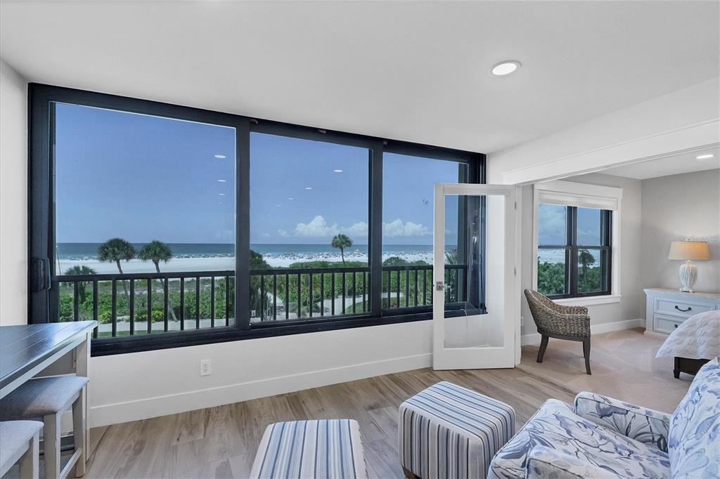 5740 Midnight Pass Road, Unit 303F Sarasota, FL 34242 - Photo 9 of 51 a spacious bedroom with a large window and a balcony