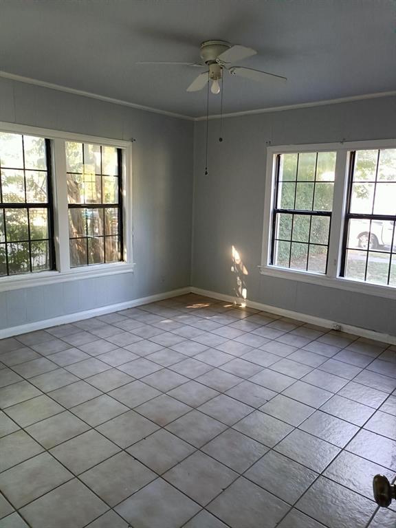 3213 8th Avenue Fort Worth, TX 76110 - Photo 6 of 15 Spare room featuring ornamental molding, light tile patterned floors, and ceiling fan