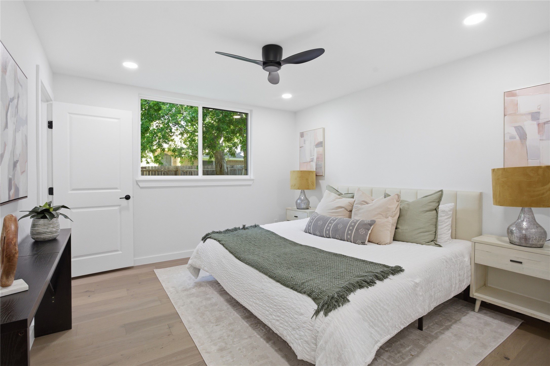 2110 Magazine Street Austin, TX 78727 - Photo 21 of 31 Relaxing and spacious primary bedroom with light wood-finish flooring, recessed lighting, and a ceiling fan
