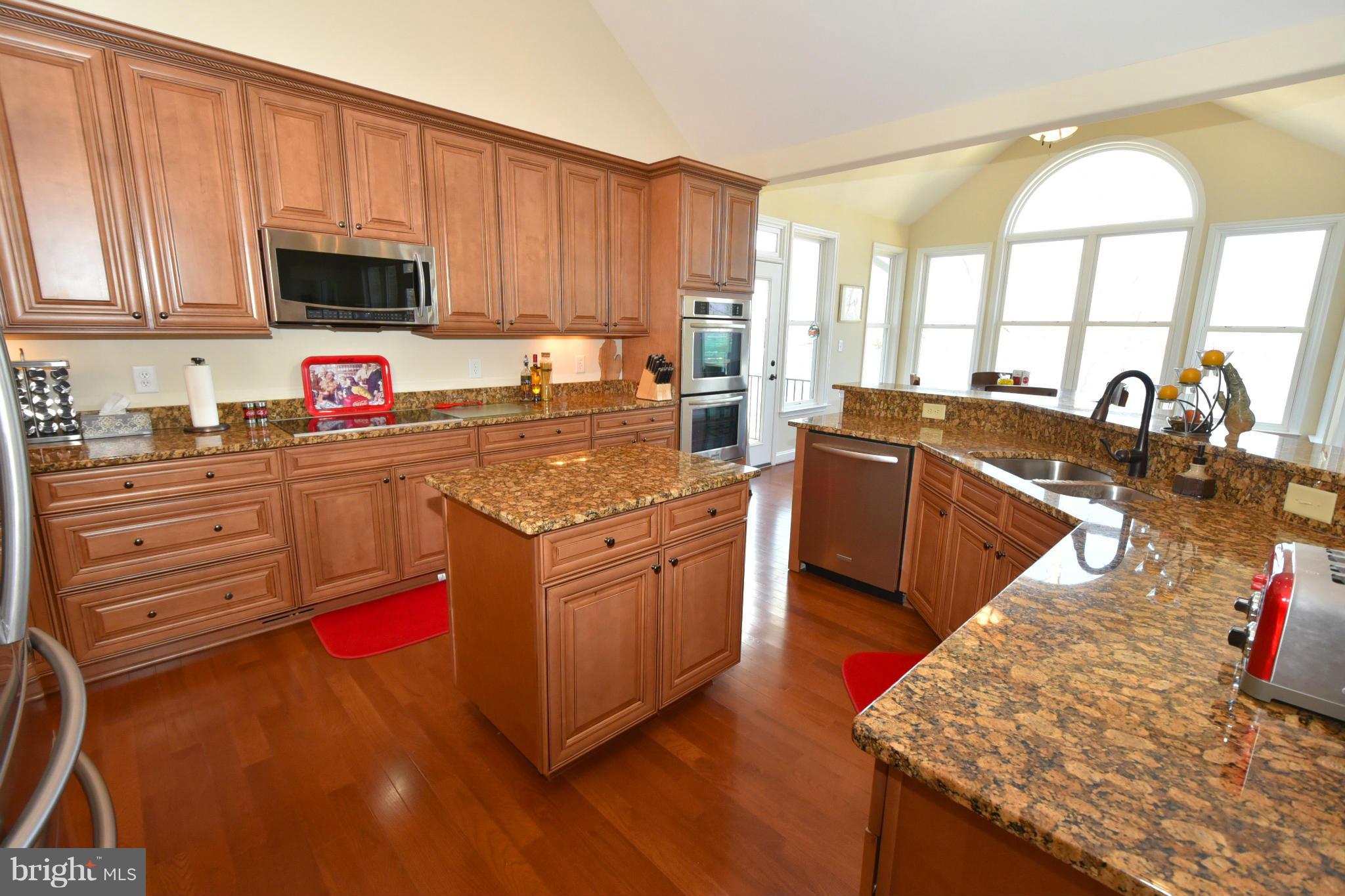 264 Lane Road Bumpass, VA 23024 - Photo 13 of 30 a kitchen with stainless steel appliances granite countertop a stove a sink and a microwave