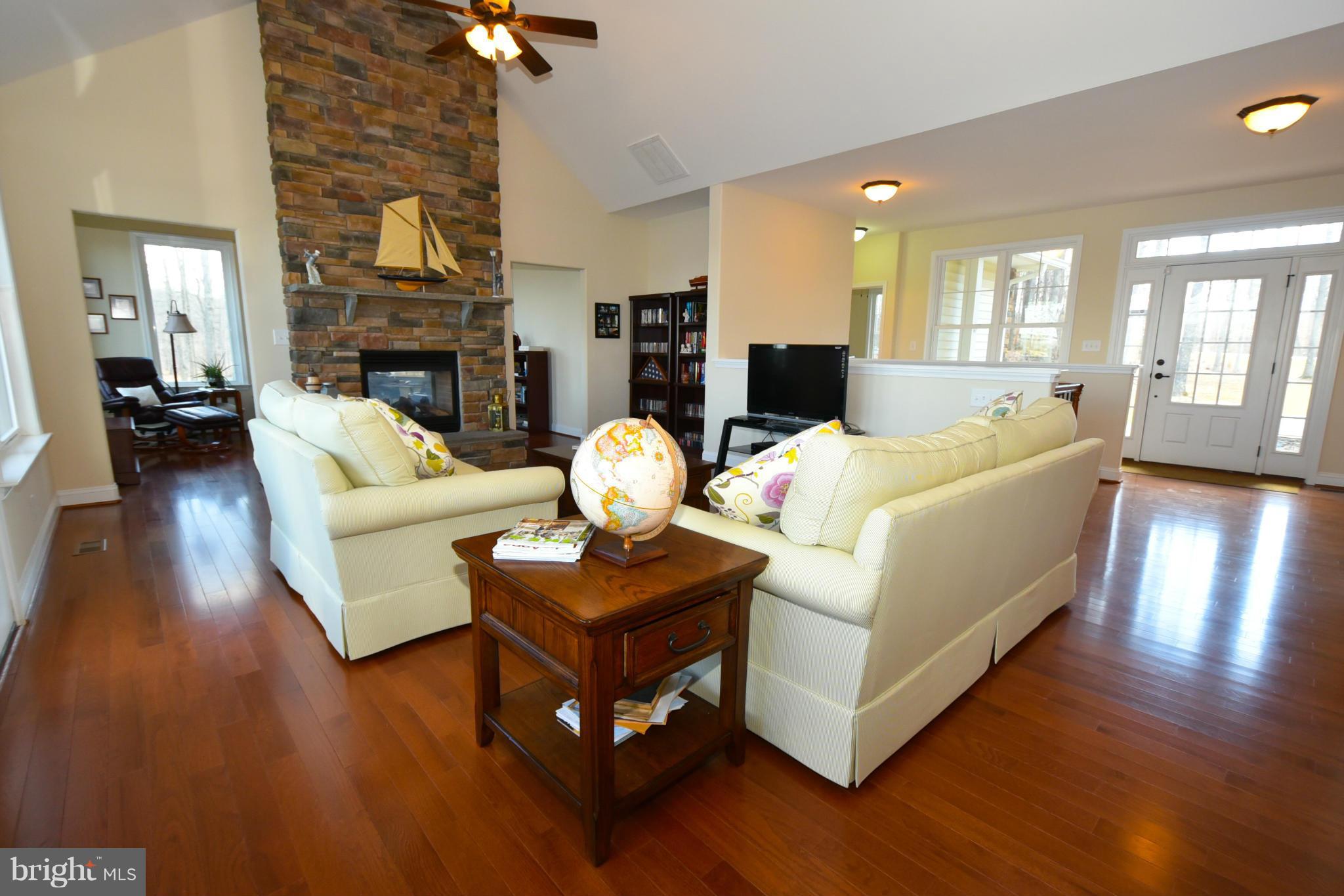 264 Lane Road Bumpass, VA 23024 - Photo 4 of 30 a living room with fireplace furniture and a wooden floor