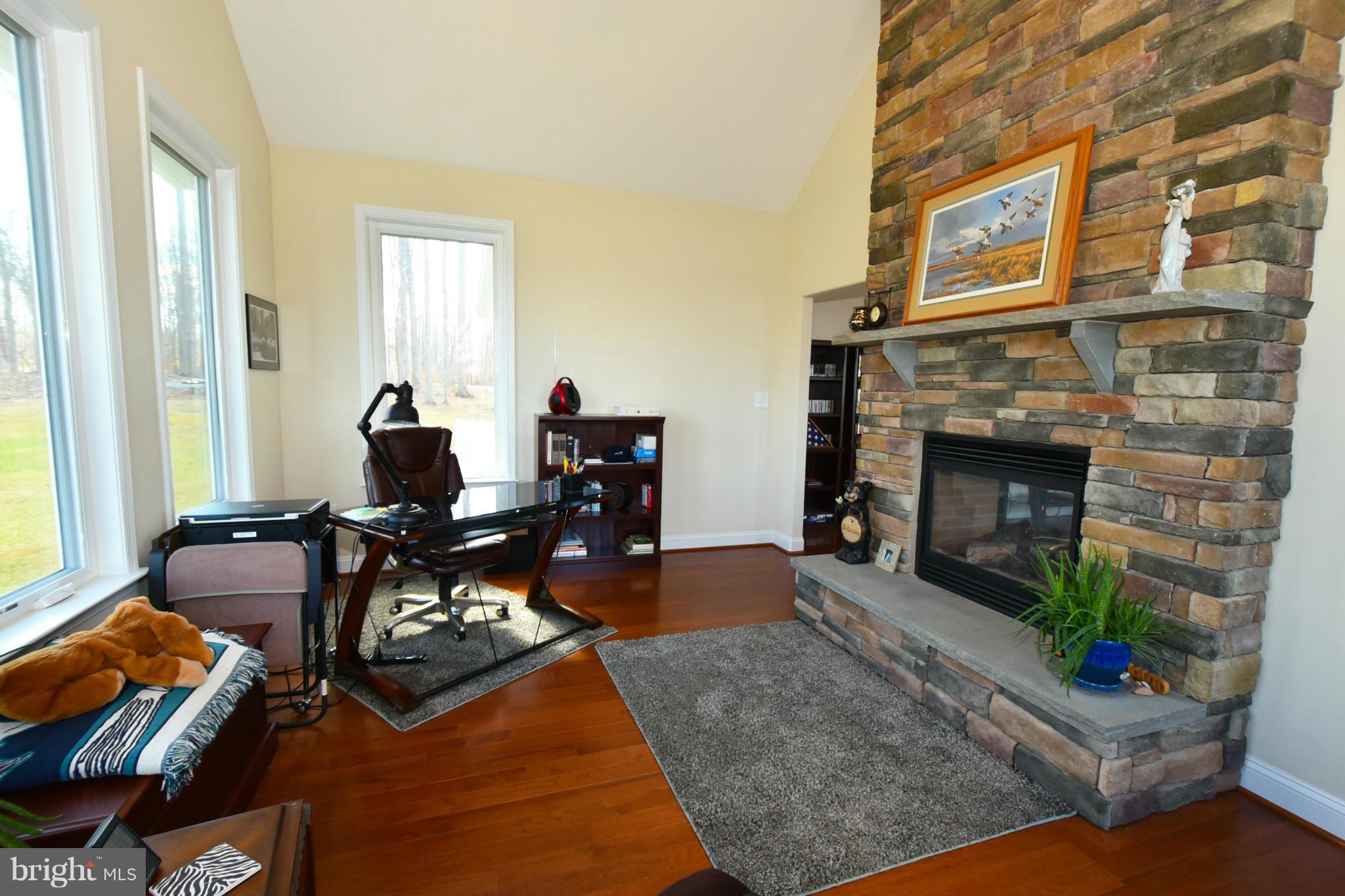 264 Lane Road Bumpass, VA 23024 - Photo 7 of 30 a living room with furniture and a fireplace