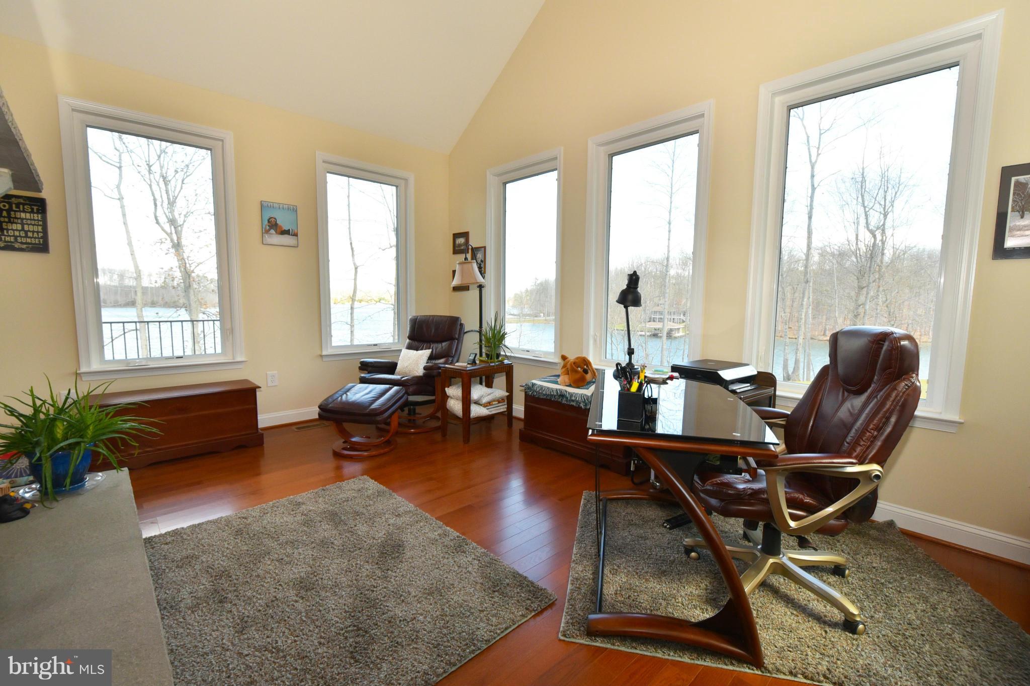264 Lane Road Bumpass, VA 23024 - Photo 8 of 30 a living room with furniture and floor to ceiling windows