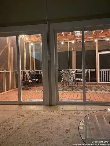 a view of a wooden deck and backyard