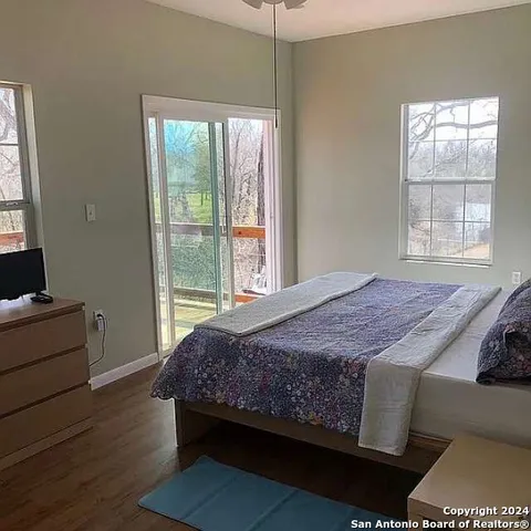 a bedroom with bed and window