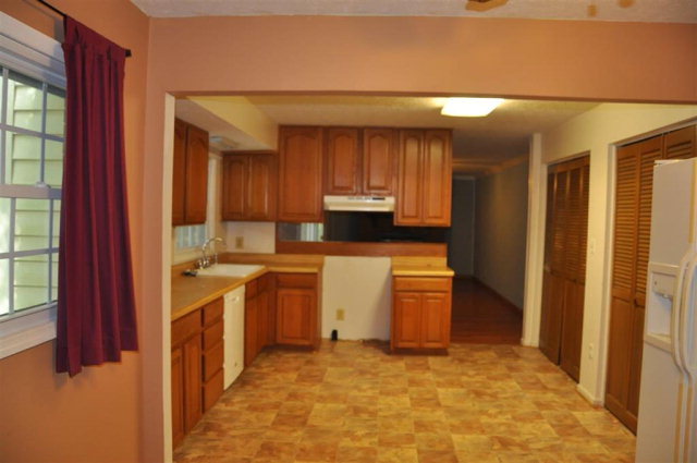 202 Delone Road Byron, GA 31008 - Photo 13 of 20 a view of a kitchen with wooden floor and electronic appliances