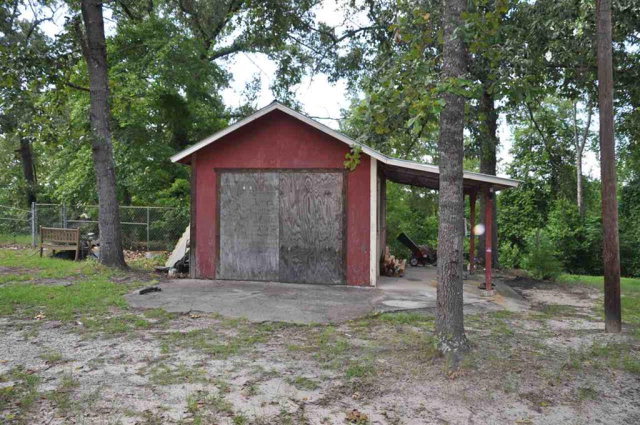 202 Delone Road Byron, GA 31008 - Photo 6 of 20 a view of a small house with a tree in the yard