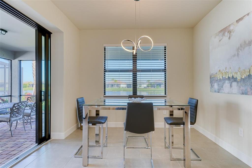 18023 Waterville Place Lakewood Ranch, FL 34202 - Photo 13 of 41 a view of a dining room with furniture and a window