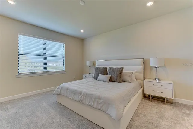 a bedroom with a bed and a night stand