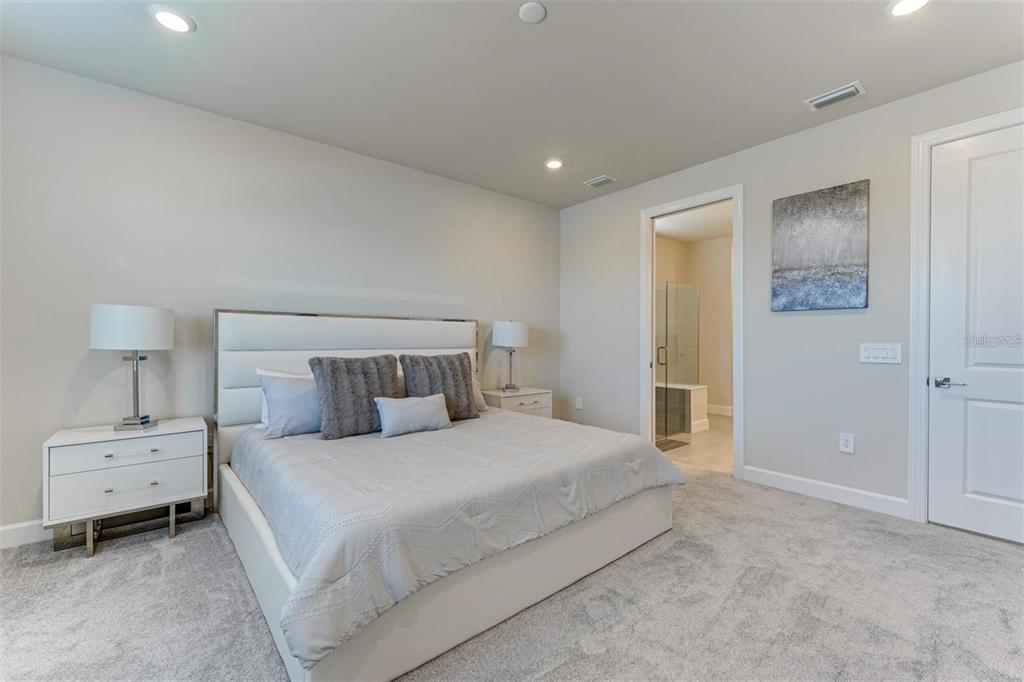 18023 Waterville Place Lakewood Ranch, FL 34202 - Photo 21 of 41 a bedroom with a bed and a night stand