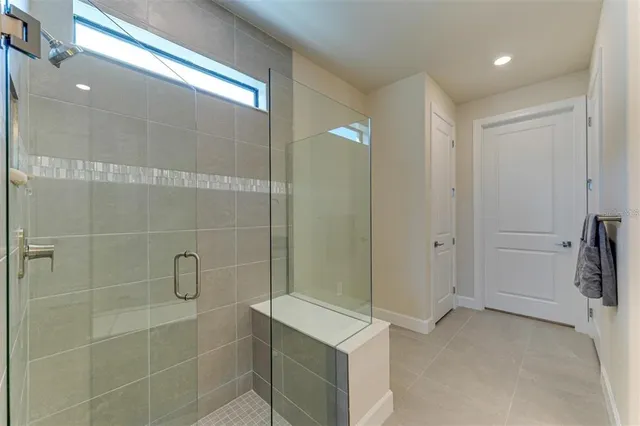 a bedroom with a large bed and a large window