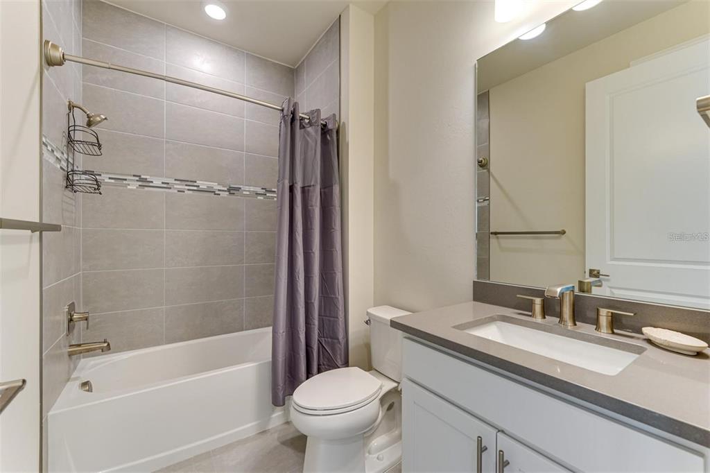 18023 Waterville Place Lakewood Ranch, FL 34202 - Photo 27 of 41 a bathroom with a granite countertop sink toilet and shower