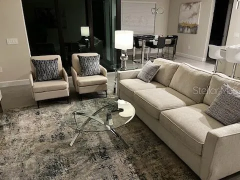 a living room with furniture and a flat screen tv
