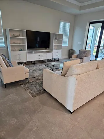 a living room with furniture and a mirror