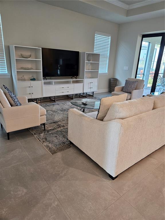 18023 Waterville Place Lakewood Ranch, FL 34202 - Photo 8 of 41 a living room with furniture and a flat screen tv