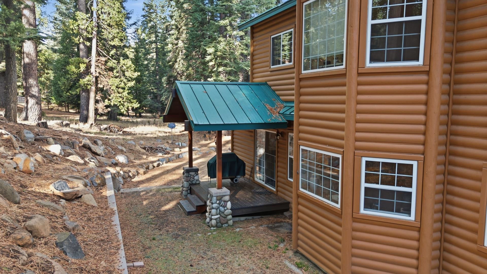 1017 Timber Ridge Road Lake Almanor, CA 96137 - Photo 43 of 45 a front view of a house with garden