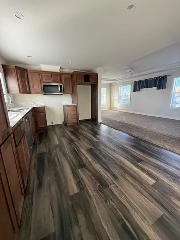 a living room with furniture and kitchen appliances