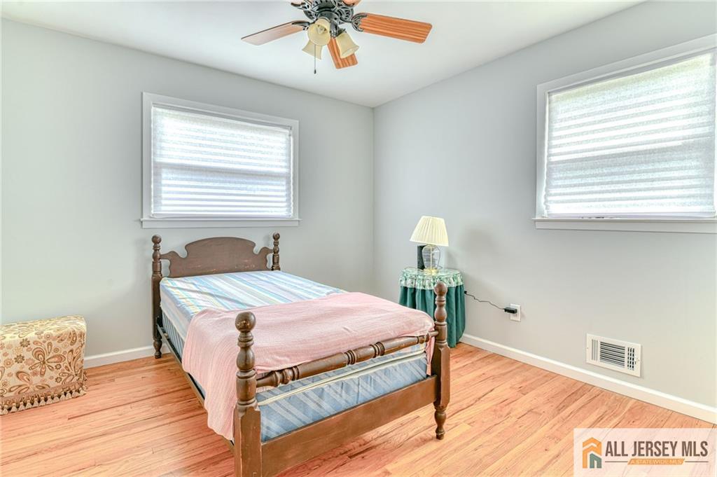 14 Gramercy Road Old Bridge, NJ 08857 - Photo 13 of 26 a bedroom with a bed and a chandelier