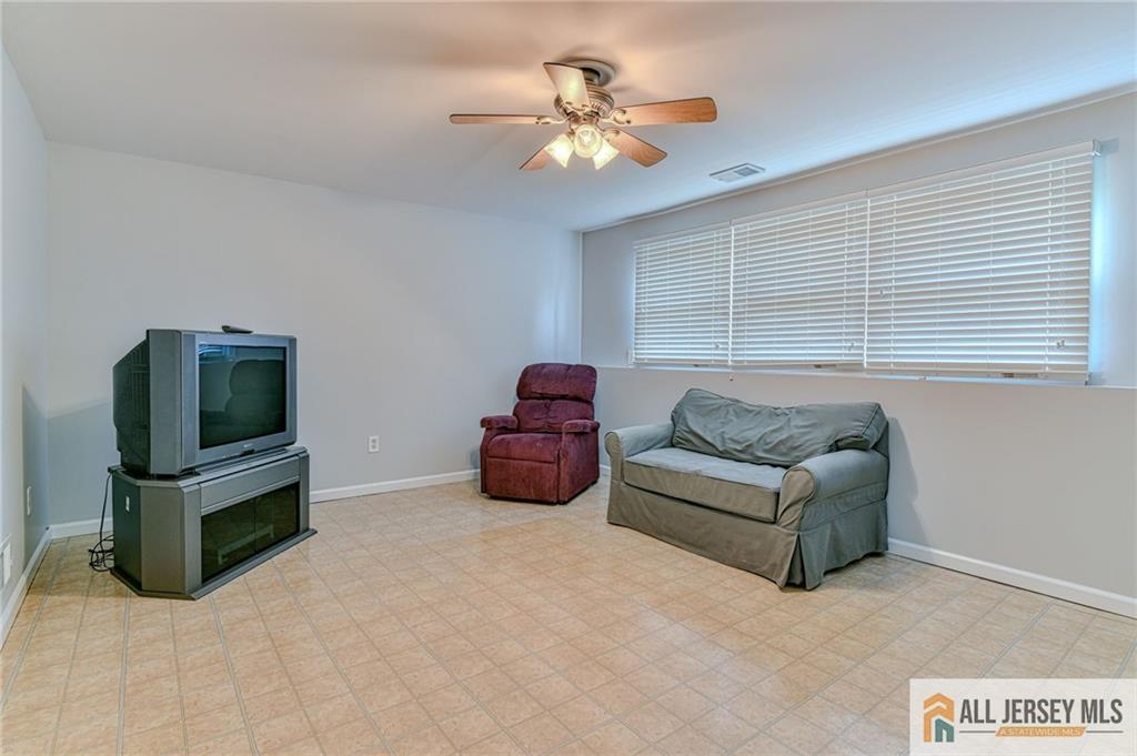 14 Gramercy Road Old Bridge, NJ 08857 - Photo 17 of 26 a living room with furniture and a flat screen tv