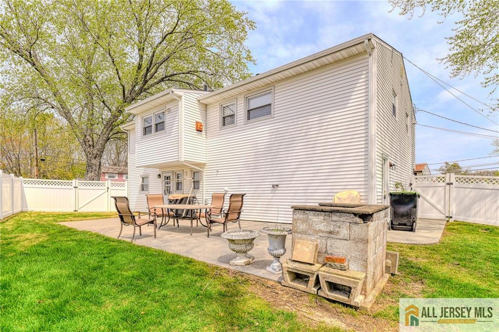 14 Gramercy Road Old Bridge, NJ 08857 - Photo 25 of 26 a view of a patio with table and chairs with wooden fence
