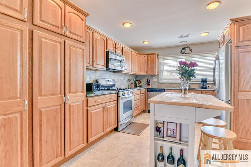 14 Gramercy Road Old Bridge, NJ 08857 - Photo 8 of 26 a kitchen with stainless steel appliances granite countertop a sink and cabinets